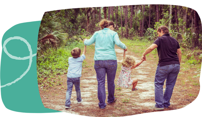 Fostering family walking in the woods